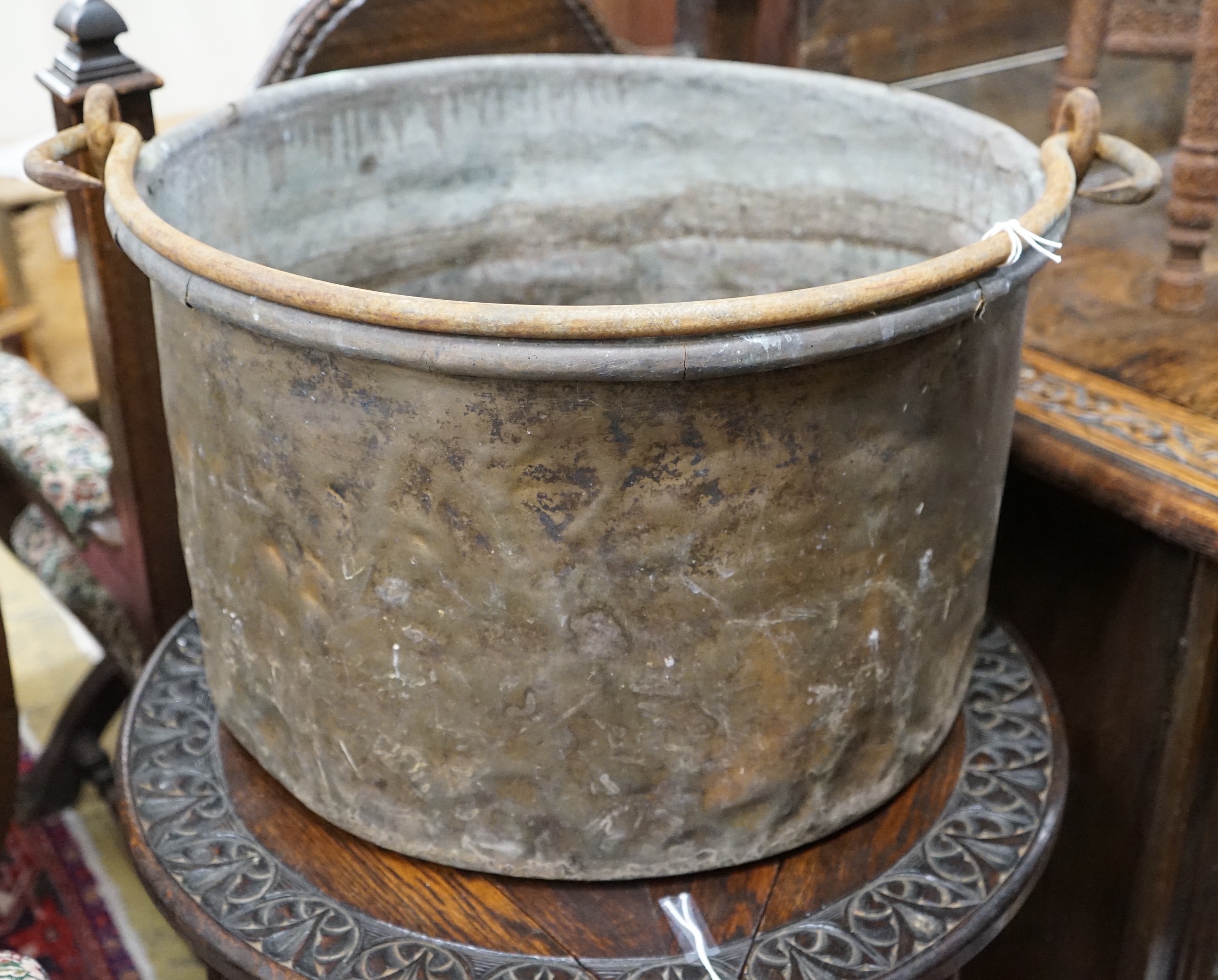 A Victorian brass and wrought iron cauldron with wrought iron swing handle, diameter 56cm, height 35cm